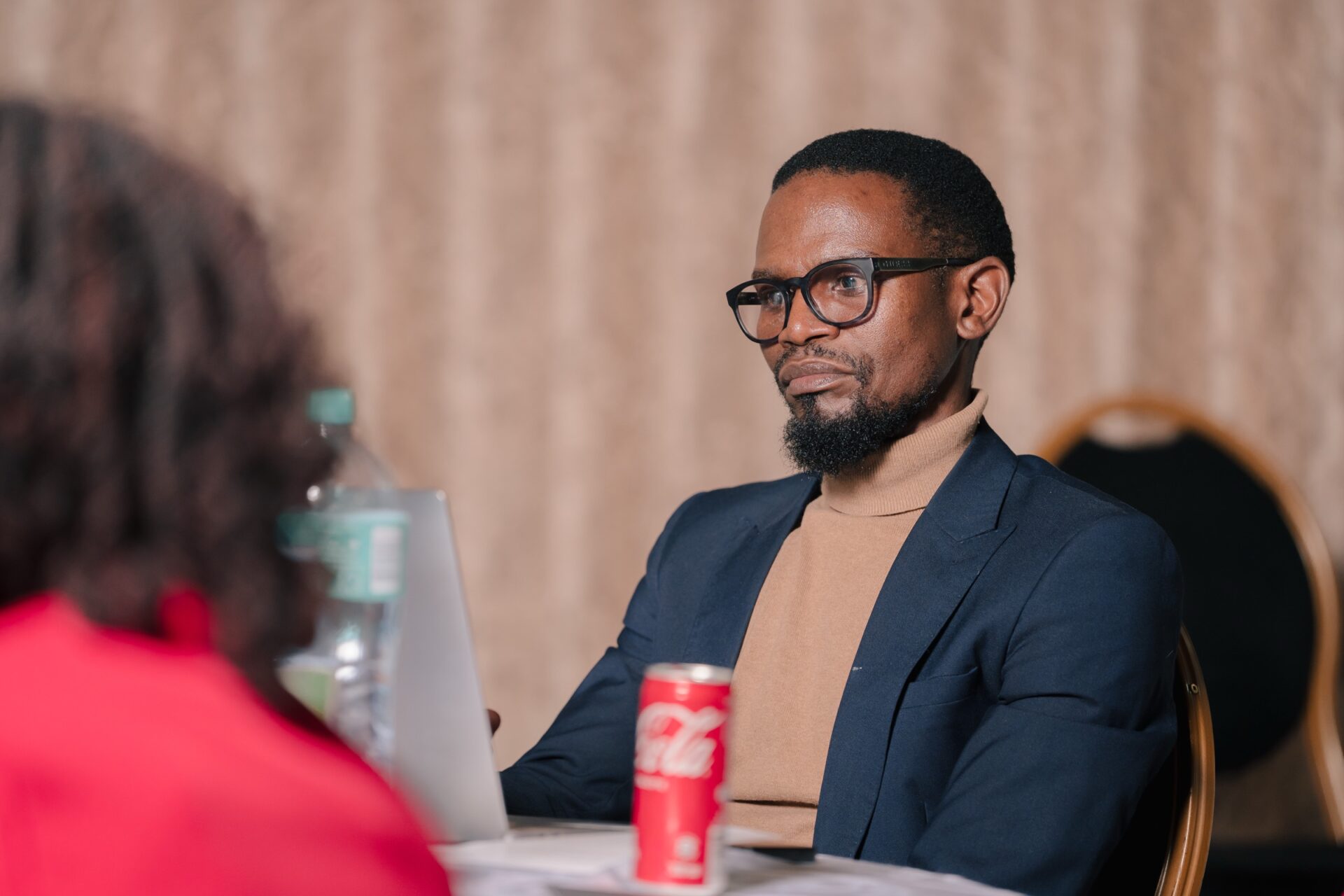 A participant listens at an ESGM dialogue, 2024