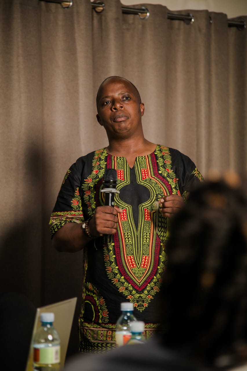 A participant speaking into a microphone